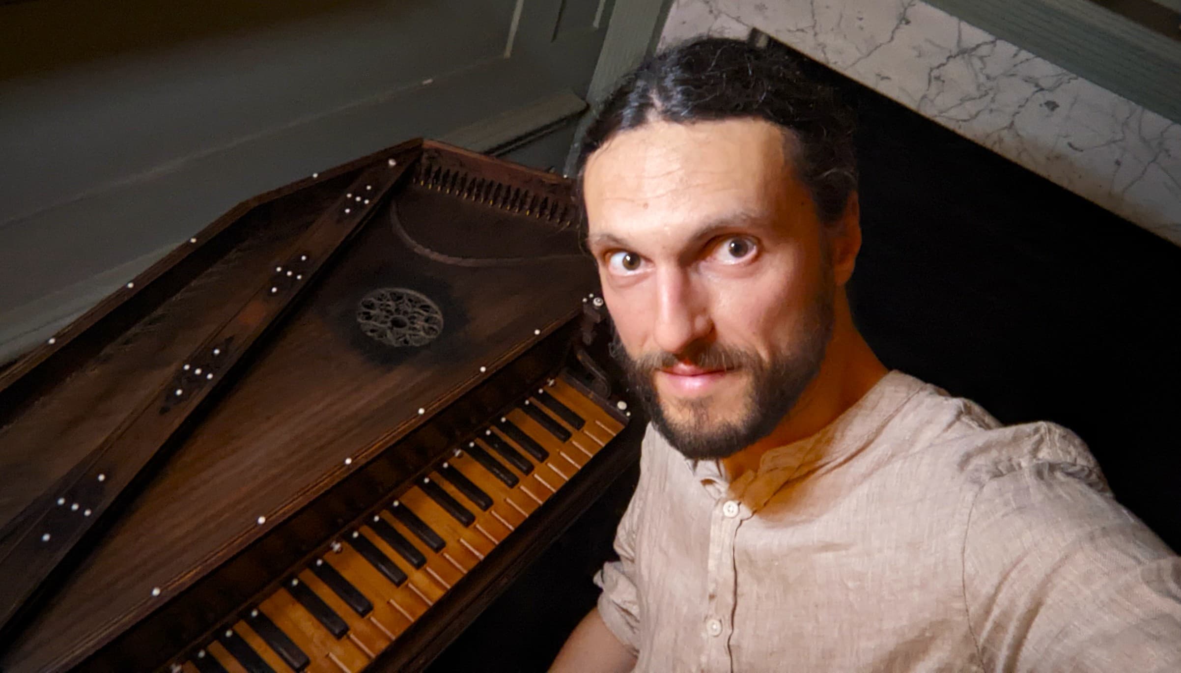 The Clavierist seated at the keyboard of an early keyboard instrument